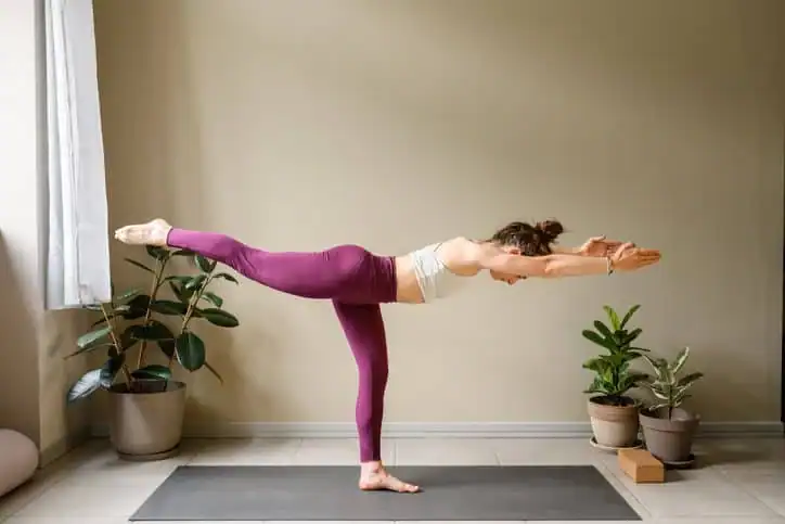 Woman doing Yoga exercise Buxton to help with toning the body. 